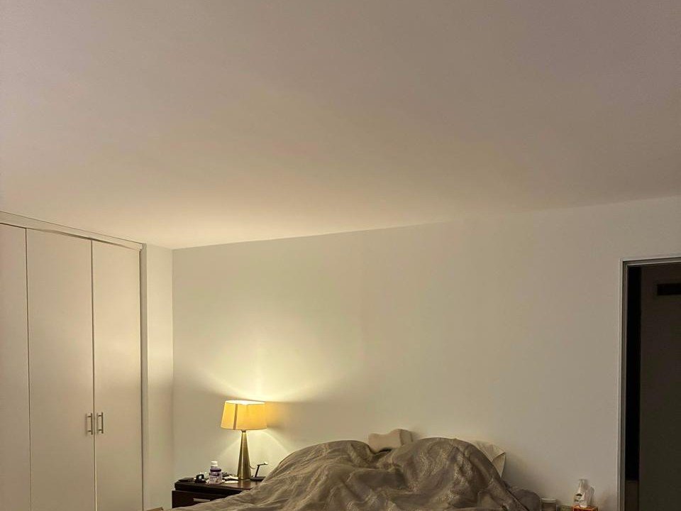 Bedroom ceiling and walls painted white in a New York apartment